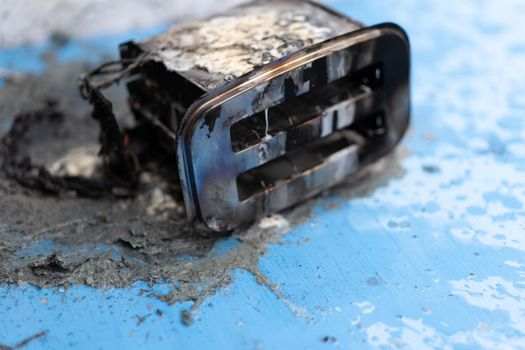 Toaster after fire. Household electrical appliance fire hazard. Overload. Short circuit. Carelessness. Safety in home. Danger home inflammation Insurance concept