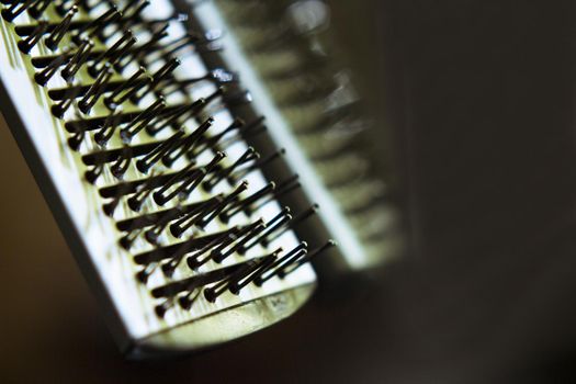 Hair brush with plastic bristles for straightening hair. No people