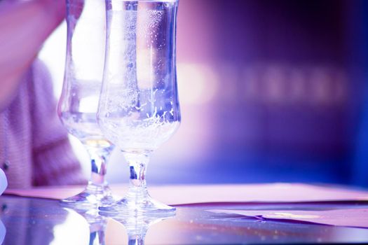 Hands holding a cigarette with empty beer glasses. Copy space