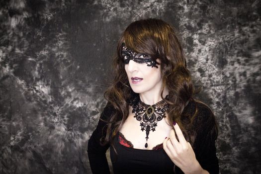 Woman disguised in gothic style for halloween party with mask