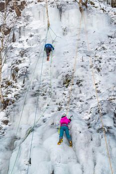 Climbing on frozen ice in Gluszca, Poland