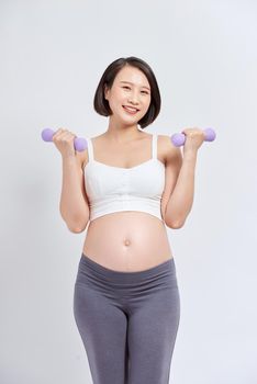 Pregnant woman is doing exercises at the gym