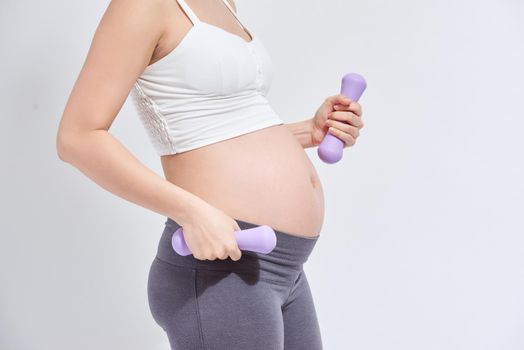 Pregnant woman is doing exercises at the gym