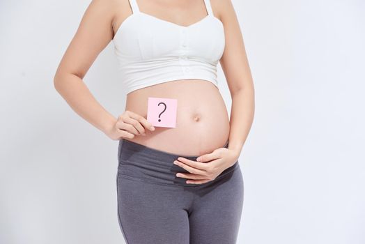 Pregnant woman with a sticky note, which is drawing a question sign, on her belly