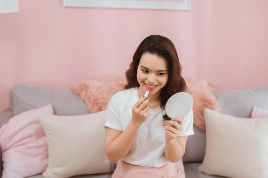 Portrait of young asian woman recording video make up lipstick cosmetic at home. Online influencer girl social media marketing live steaming concept