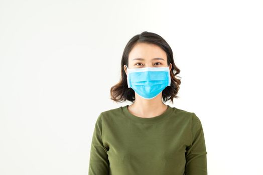 Asian woman wearing facial mask for protection from air pollution or virus epidemic on white background