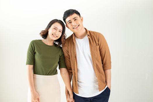 Portrait of young couple smiling on white background