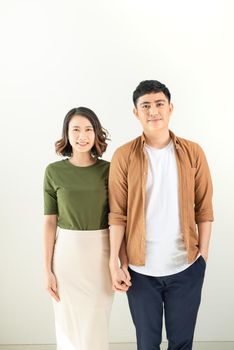 Portrait Of Happy Young Loving Couple Looking At Camera Isolated On White Background