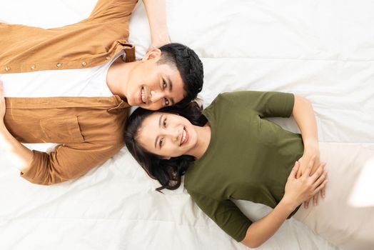 Overhead close up of young couple lying in bed together