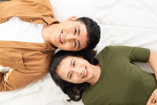 Overhead close up of young couple lying in bed together