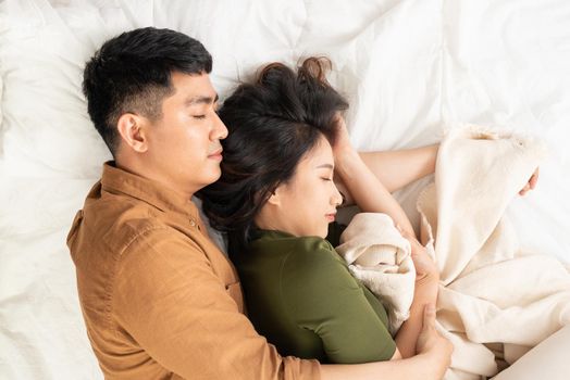 Joyful loving couple in bedroom together