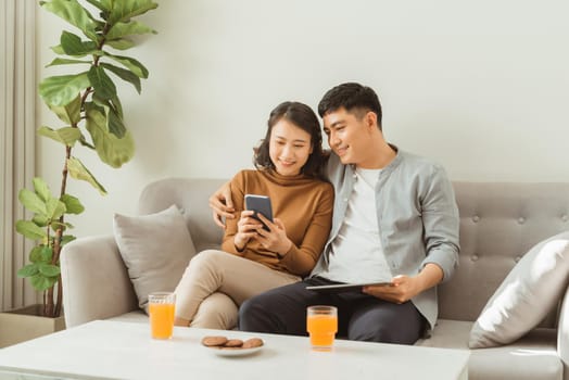 Couple Use tablet pc Together In Living Room, Happy Smiling Woman,