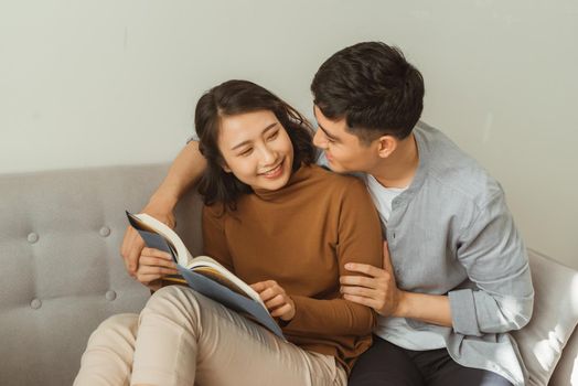 smiling couple looking romantically at each other book