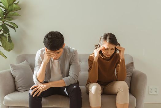 Couple not talking after a fight on the sofa in living room at home