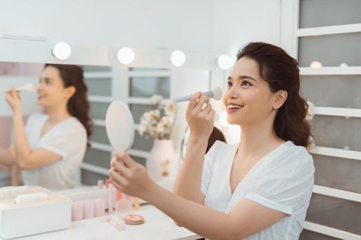 Happy Girl gets blush on the cheekbones. Powder, rouge make-up