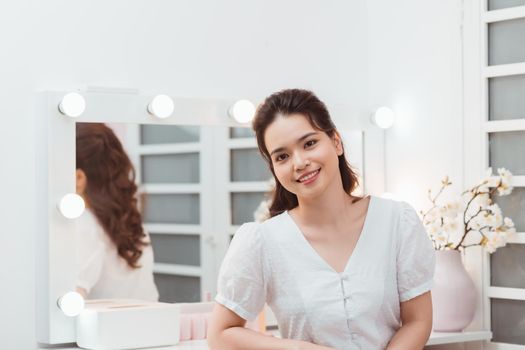 Portrait Of Beautiful Happy Young Female With Fresh Healthy Skin Looking near Mirror.