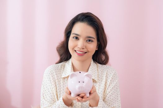 Young woman with piggy bank