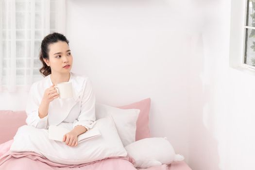 Girl reading a book in bed