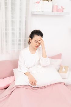 Young ill woman in bed at home