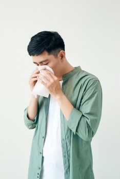 Sick young man handsome and sneeze isolated on white wall background. Concept of sick. Asia people.