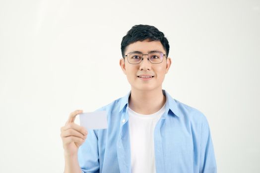 Young asian man showing empty card isolated on white background.