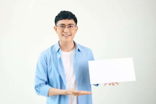 Asian young man showing pannel isolated on white background.
