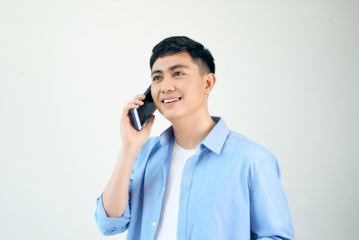 handsome Asian young man talk on phone