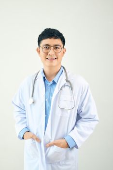 A handsome doctor with stethoscope standing confidently on white background