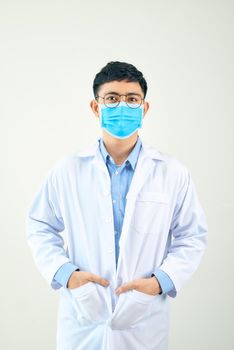 Young asian man in medical field, wearing a white coat and face mask,