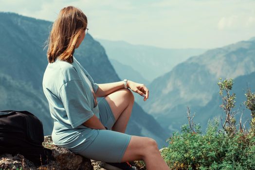 Woman on the top of Altai mountain, Katu Yaryk mountain pass and the valley of the river of Chulyshman, beauty summer day landcape. Travel, leisure and freedom concept