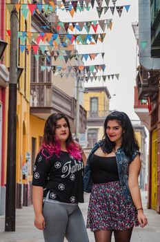 Portrait of beautiful chubby caucasian women in the street smiling to the camera