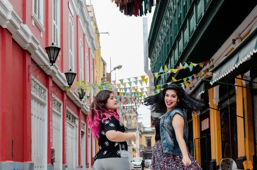 Portrait of beautiful chubby caucasian women in the street smiling to the camera