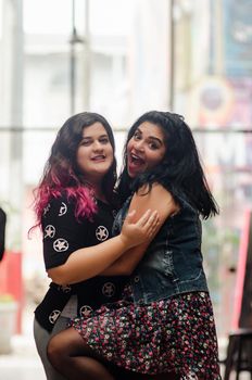 Portrait of beautiful chubby caucasian women in the street smiling to the camera