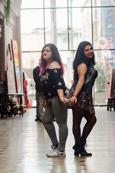 Portrait of beautiful chubby caucasian women in the street smiling to the camera