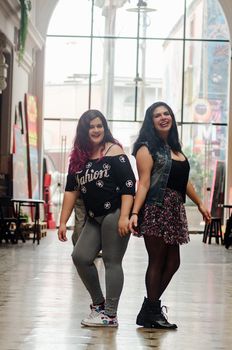 Portrait of beautiful chubby caucasian women in the street smiling to the camera