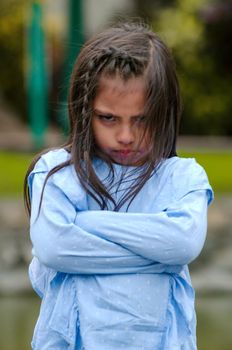 Angry little girl showing frustration and disagreement in the street