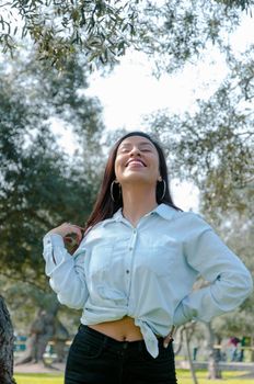 Woman smiling looking up to blue sky taking deep breath celebrating freedom. Positive human emotion face expression feeling life perception success peace mind concept. Free Happy girl enjoying nature