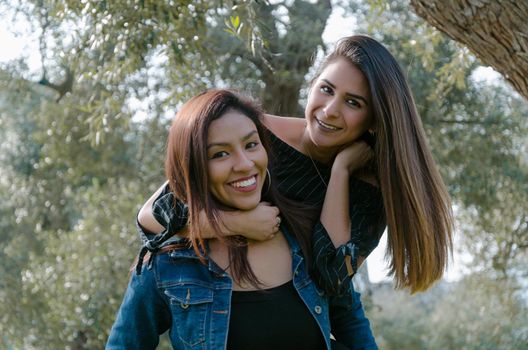 Outdoor lifestyle portrait of two best friends, smiling and having fun together