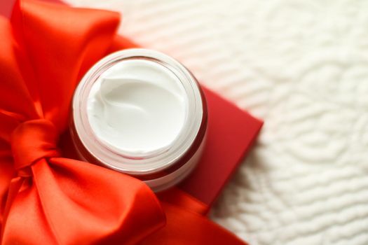 Beauty, cosmetics and skincare styled concept - Luxury face cream jar and red gift box