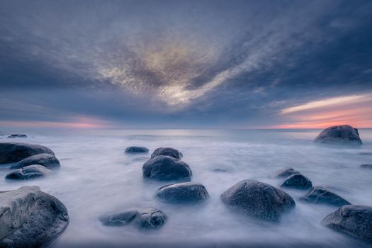 Orre beach in Norway, rocks towards the sunset