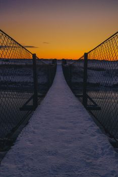 Bridge used for hiking in the beach area - sunset and snow at winter