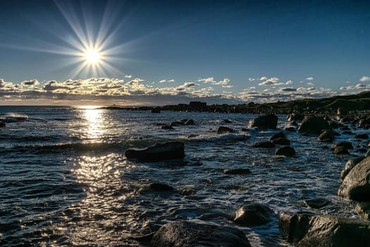 Rocky beach in winter time as the sun is about set.