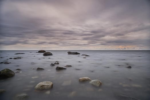 Long exposure of water movements surrounding rocks at the beach