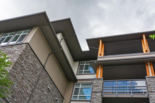 Residential building roof silhouette on overcast sky background.