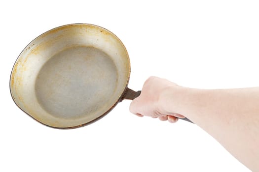 bare caucasian hand holding empty old aluminium frying pan.