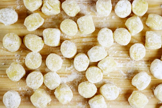 Raw gnocchi on  wooden board   , uncooked food with flour