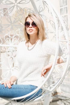 Beautiful stylish woman in sunglasses relaxing on a sunny day.