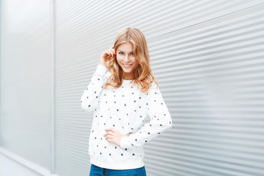 Portrait of fashionable fun girl with a beautiful smile on a light background.