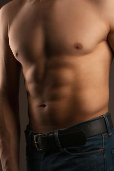 Body of a man in the studio. Relief abdominal muscles. 