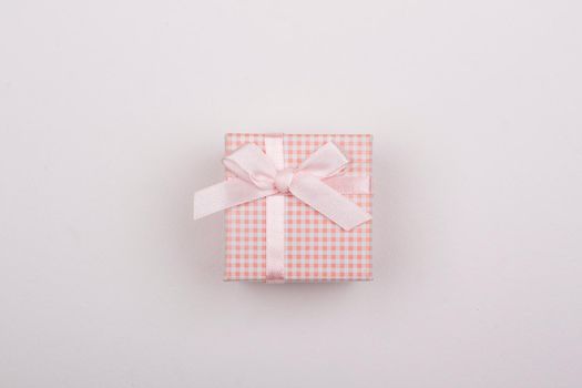 Pink gift with bow on a white background.